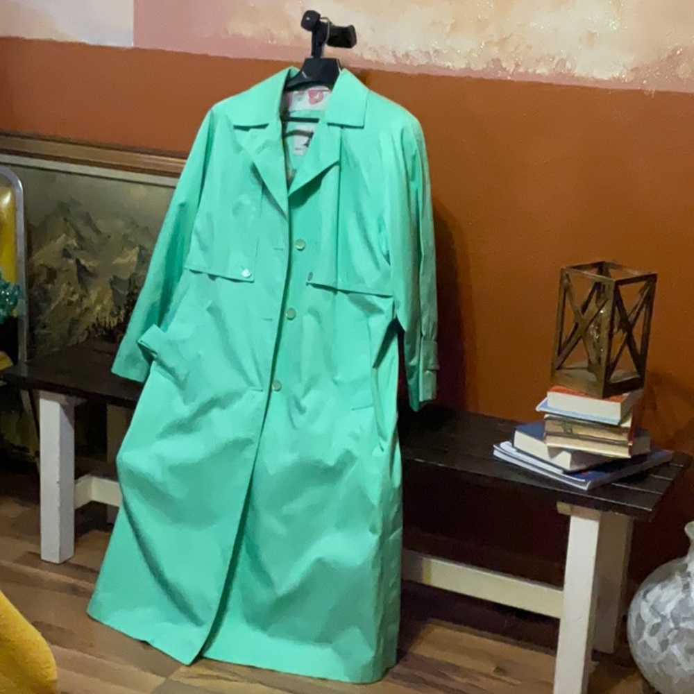 Pastel green trench coat with ribbon pattern lining.